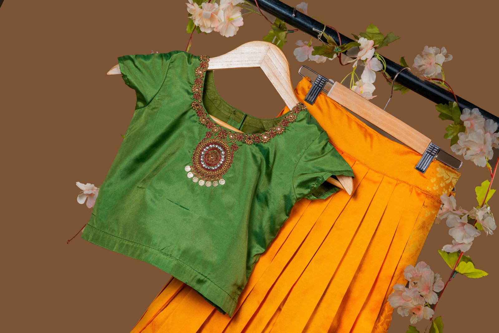 Traditional Green Silk Blouse with Coin and Bead Embellishment, Paired with Golden Yellow Pleated Skirt